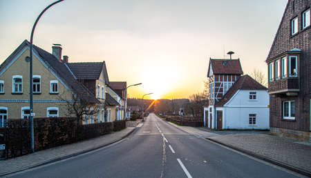 Asphalt road in the town and sunset, rural landscape.の写真素材