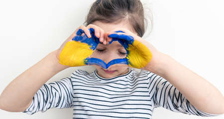 Childs hands painted on Ukraine flag colors.の写真素材