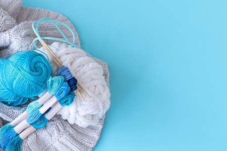 Threads of different colors on a blue background.の写真素材