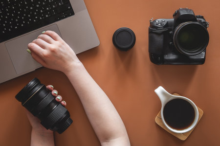 Photographers workplace with camera and lens, flat lay.の写真素材