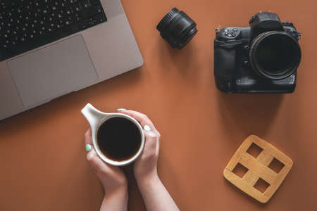 Photographers workplace with camera and lens, flat lay.の写真素材