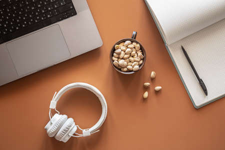 Flat lay, workplace with computer, notepad and headphones.の写真素材