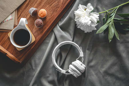 Cup of coffee and muffins on a tray in bed, flat lay, breakfast in bed.の写真素材