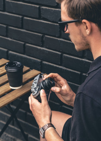 Vintage film camera and a glass of coffee on a wooden table.の写真素材