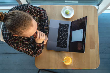 A man works at a computer, top view.の写真素材