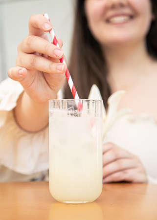 Close-up, a glass with cold lemonade in a cafe on the table.の写真素材