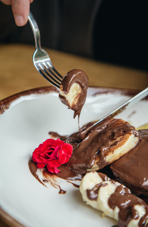 Close-up, delicious pancakes with chocolate and banana for breakfast.の写真素材