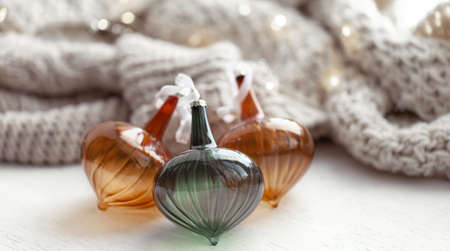 Cozy winter background with Christmas balls and knitted element.の写真素材
