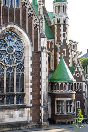 Ancient church with stained-glass windows and windows, part of the building.の写真素材