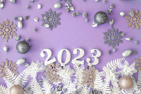 Lilac Christmas background with numbers 2023 and decor details, flat lay.の写真素材