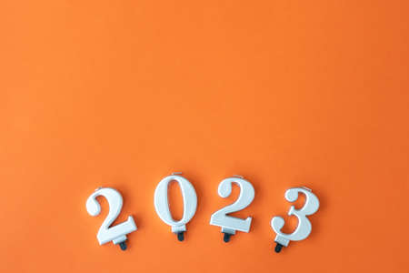 Flat lay, orange Christmas background with numbers 2023.の写真素材