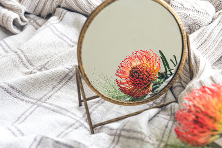 Beautiful background with the reflection of an exotic flower in the mirror.