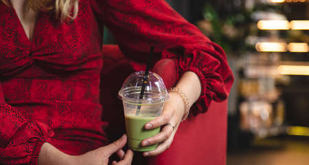 Close-up, green drink ice matcha latte on a blurred background in a cafe.の写真素材
