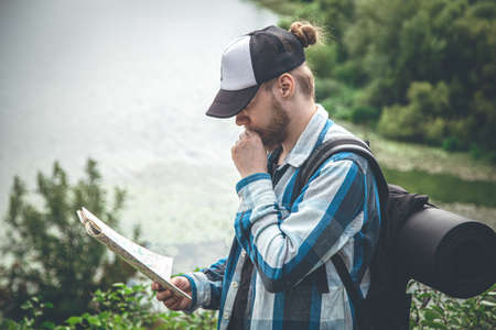 Male traveler looking at the map, hiking concept.の写真素材