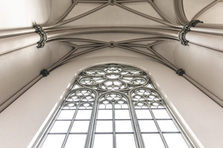 Bright interior of the church with stained-glass windows, view from below.