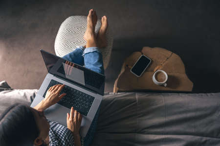 A young woman working on a laptop at home.の写真素材