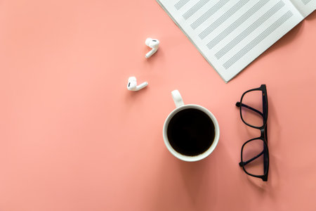 Notebook, glasses and coffee on a pink background, flat lay.の写真素材