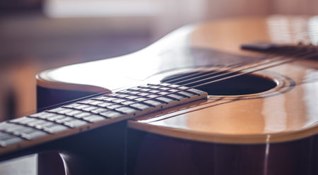 Close-up, acoustic guitar on a blurred background.の写真素材