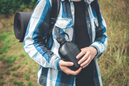 Close-up, a bottle of water in the hands of a traveler.の写真素材