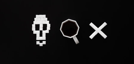Skull bones from sugar and cup of coffee on black background, flat lay.の写真素材