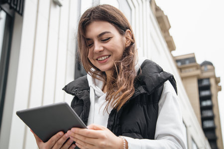 Business young woman with a tablet on the background of the building.の写真素材