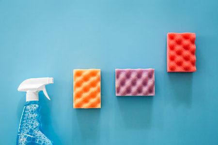Glass cleaner spray and sponge on blue background, flat lay.の写真素材