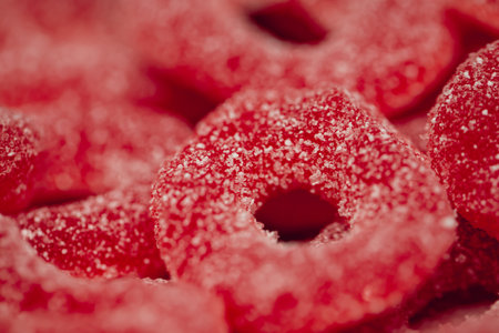 Red gummies jelly candies in sugar, background.の写真素材