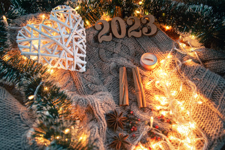 Christmas background with spices, candle, numbers 2023 and garlands.の写真素材