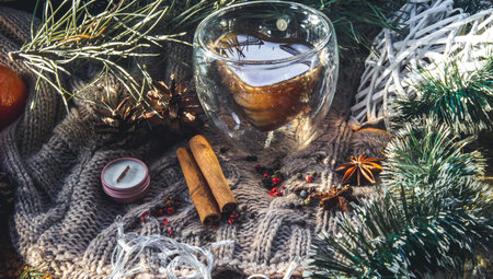 Christmas background with spices and decor details on a knitted background.