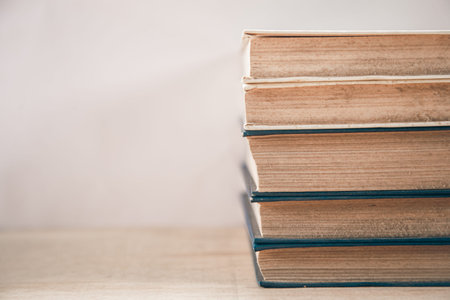 Old books stacked on a white background.
