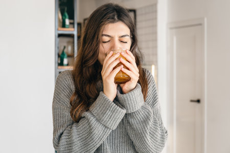Attractive young woman with a glass of coffee in a coffee shop interior.の写真素材