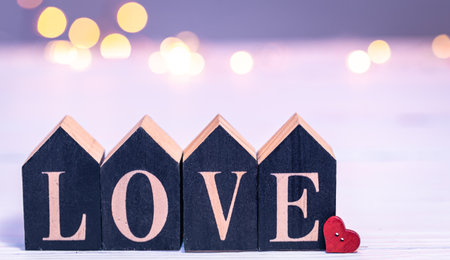 Decorative word love on a blurred background with bokeh lights.の写真素材