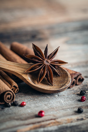 Close-up, star anise and cinnamon sticks on a wooden background, macro shot.