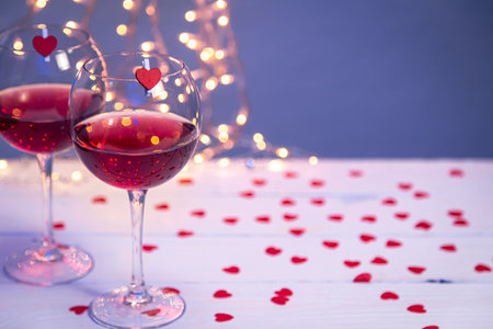 Background with glasses of wine, romantic dinner for Valentines day concept.の写真素材