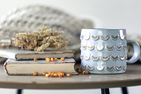Cozy home composition with books on the table close-up.