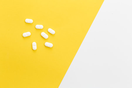 Pills on a yellow background, conceptual minimalism, copy space.の写真素材