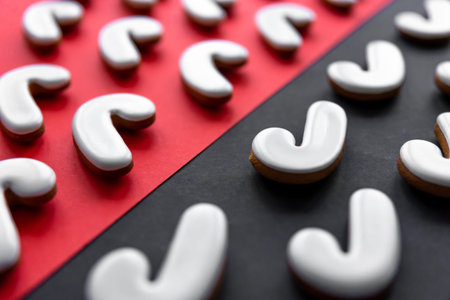 A lot of gingerbread candy cane shaped cookies on a colored background, close up.