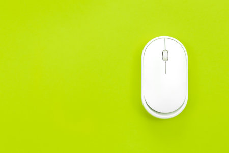 Computer mouse on a green background isolated, flat lay, copy space.の写真素材