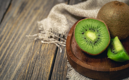Close-up, cut fruit kiwi on a wooden background, rustic style, copy space.の写真素材