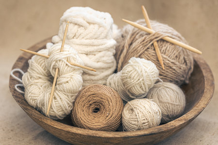 Wooden bowl with threads of pastel colors for knitting with yarn close-up.の写真素材