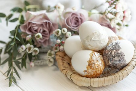 Festive Easter composition with stylish decorative eggs and flowers, close-up.