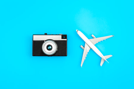 Vintage camera and airplane on a blue background, flat lay.の写真素材