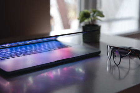 Close up of laptop keyboard colorful neon illumination, backlit keyboard.