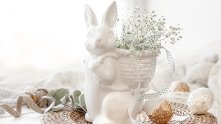 Easter composition with a ceramic hare and gypsophila flowers.