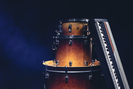 Drums and musical keys on a black background isolated.の写真素材