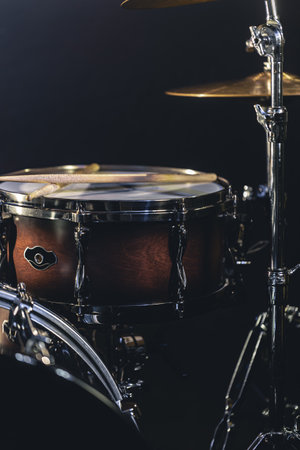 Snare drum on a blurred dark background, part of a drum kit.の写真素材