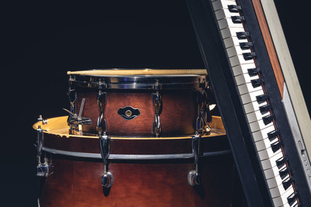 Drums and musical keys on a black background isolated.の写真素材