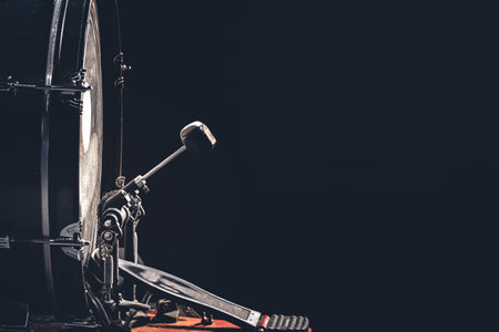 Bass drum with pedal, musical instrument on black background.の写真素材