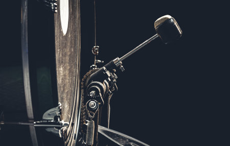 Bass drum with pedal, musical instrument on black background.の写真素材