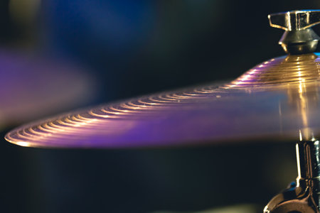 Drum cymbal close-up on a dark blurred background.の写真素材